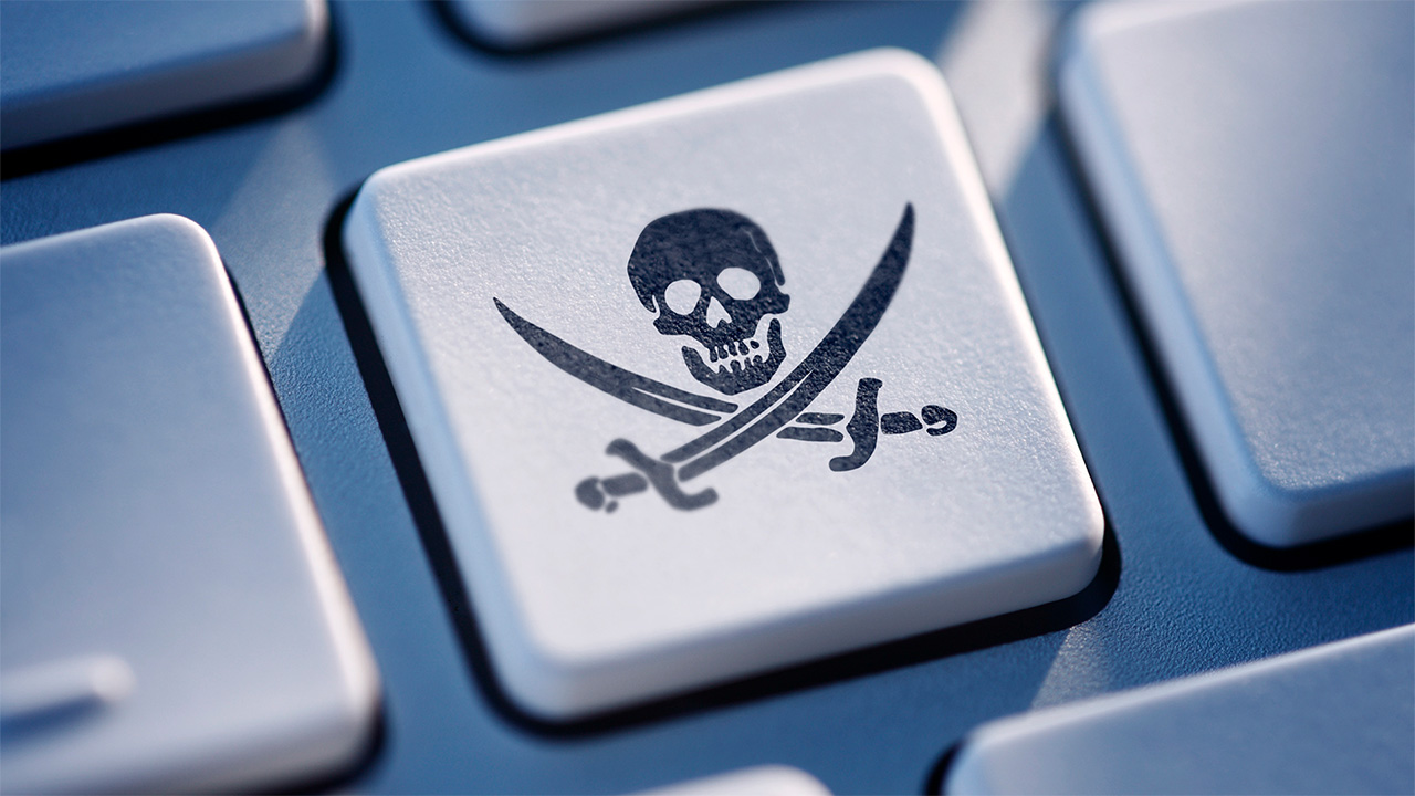 White keyboard key with a black skull and swords pirate symbol