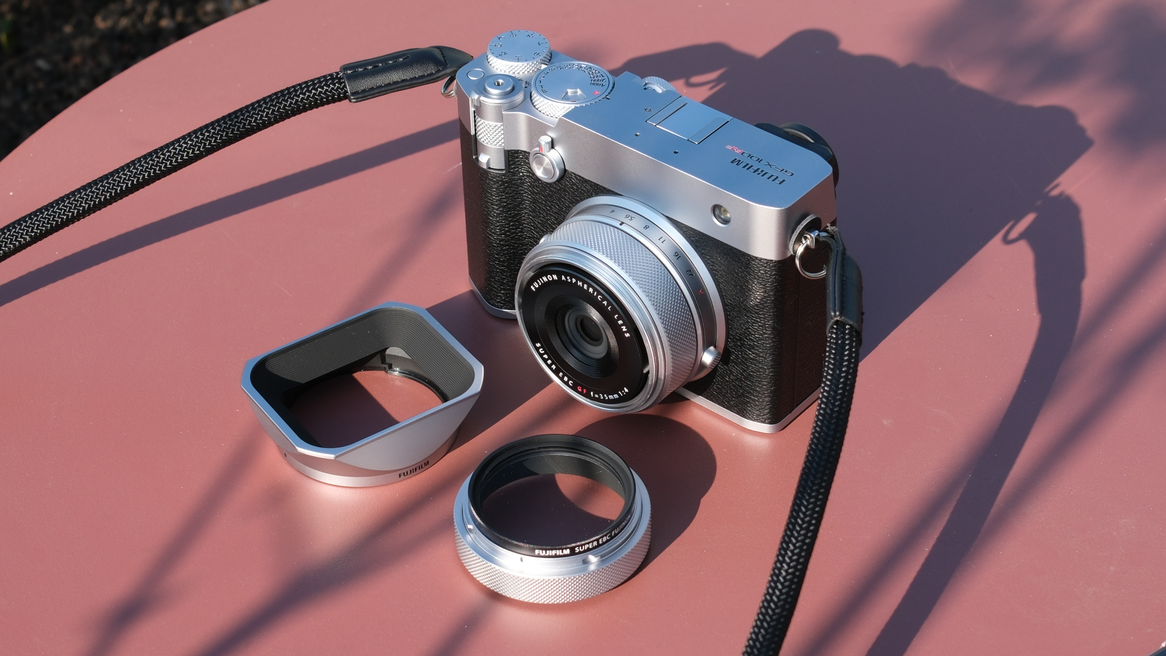 Fujifilm GFX 100RF camera on a red table in bright sunlight
