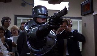 Peter Weller as RoboCop in RoboCop aiming a gun