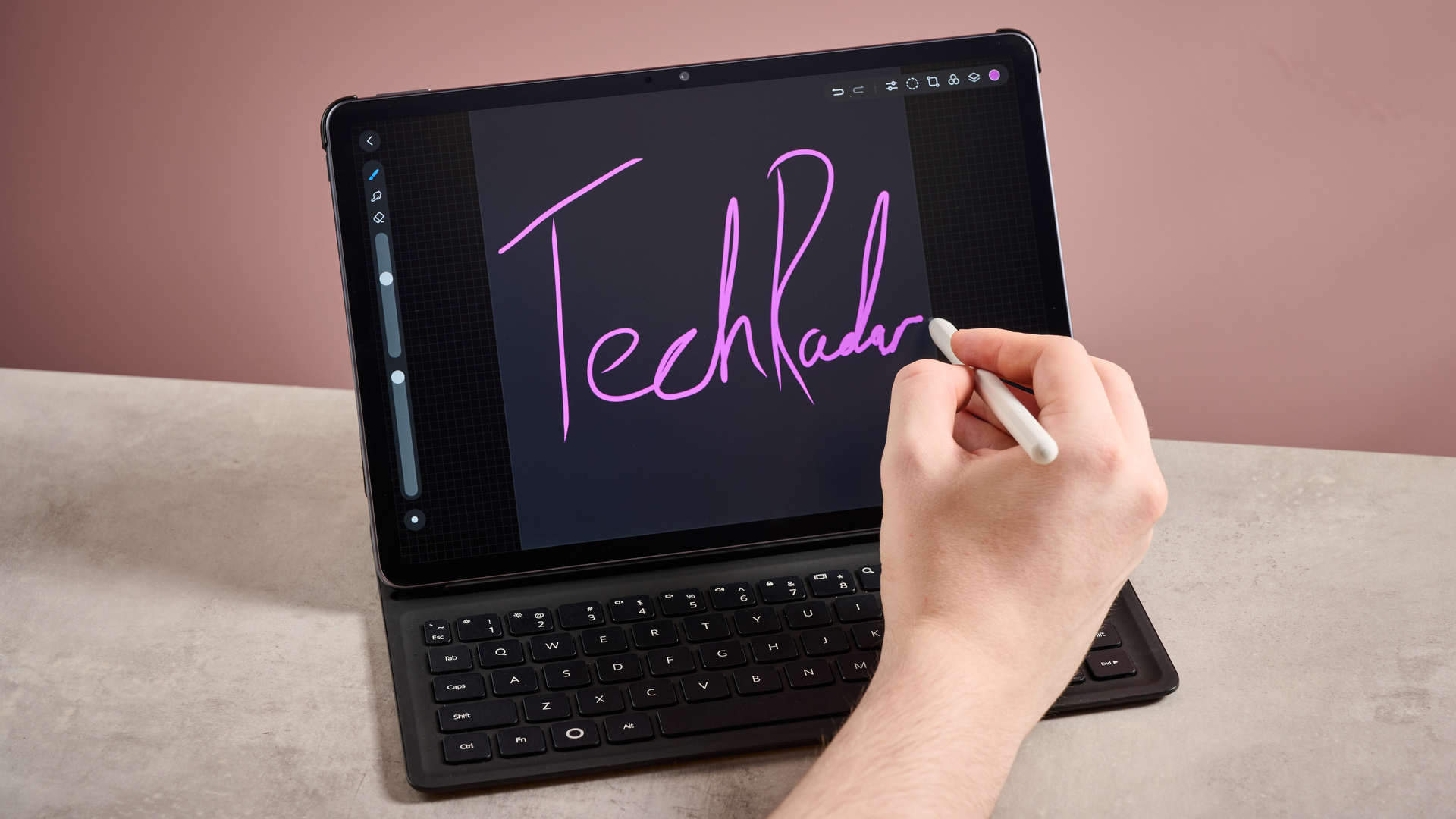 Person drawing 'TechRadar' on the Huawei MatePad 11.5