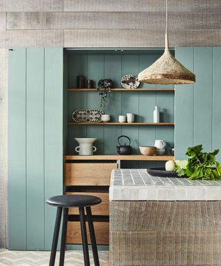 blue kitchen with open wooden shelving