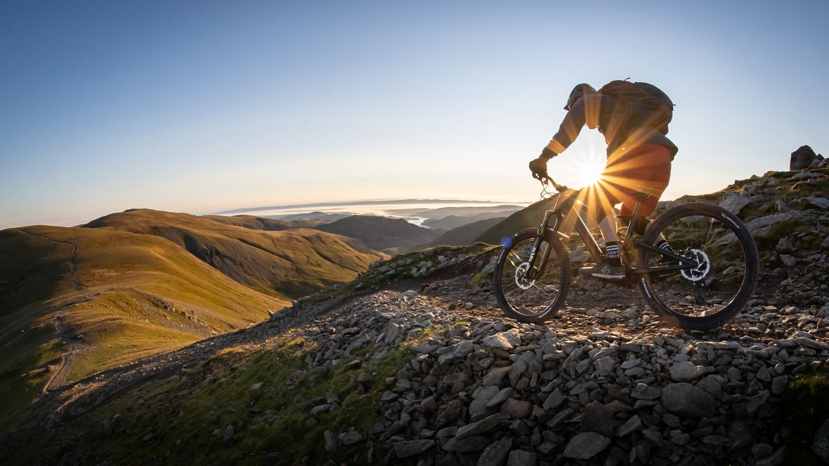 A rider on a trail at sunset