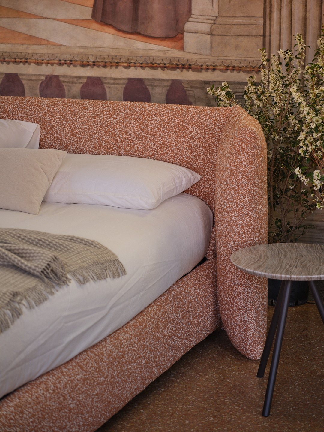 pink upholstered bed with foldable headboard