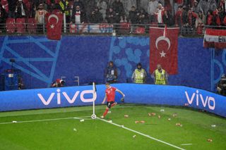 Marcel Sabitzer takes a corner with objects being thrown onto the pitch during Turkey's 2-1 win over Austria at Euro 2024