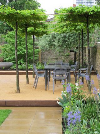 urban patio made from sandstone with grey metal chairs