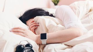 Woman sleeping wearing an Apple Watch