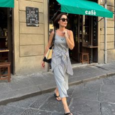 A French woman wearing a striped shirt around the waist