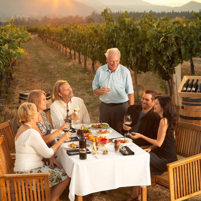 Family eating dinner in vineyard
