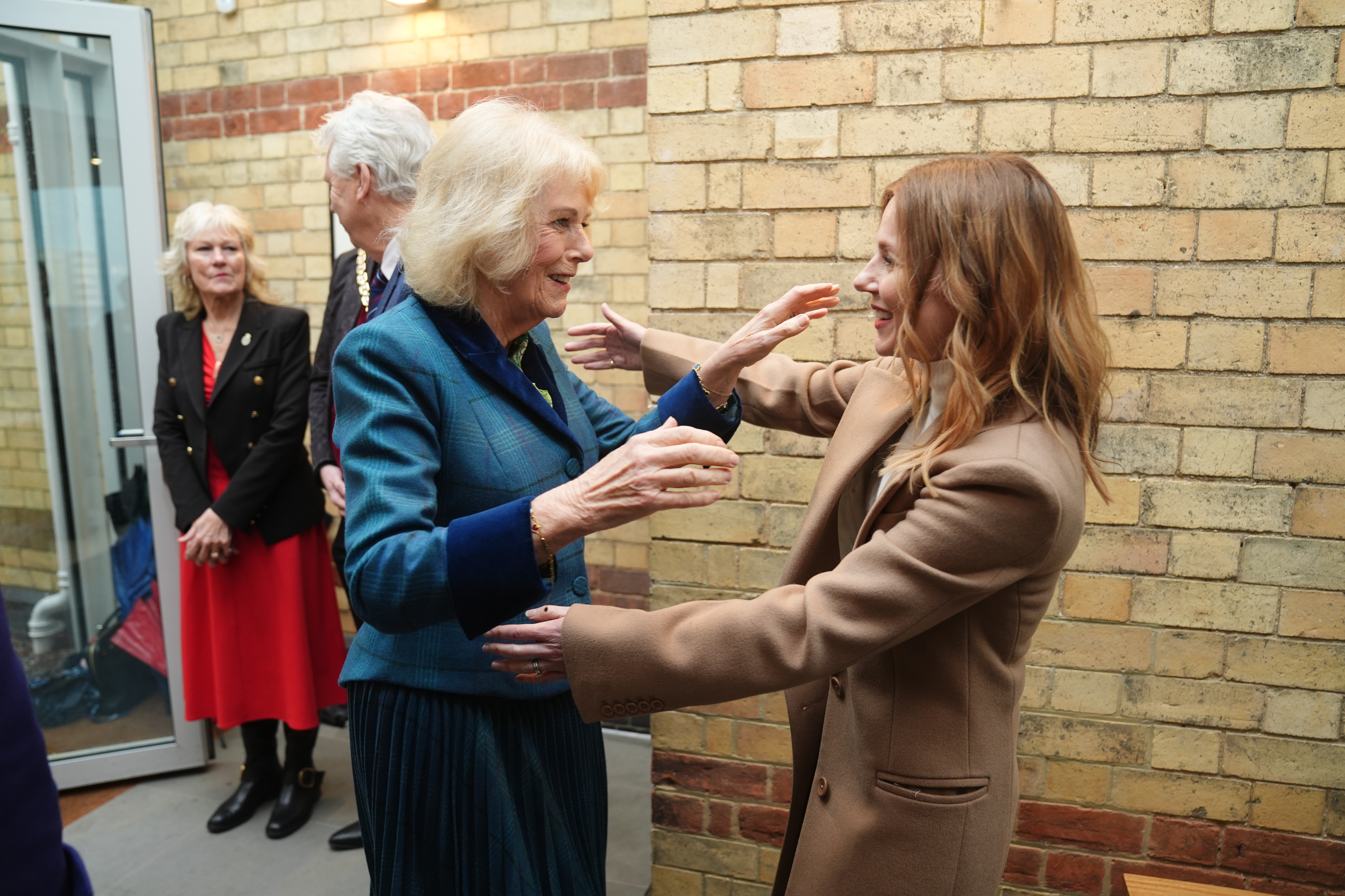 Queen Camilla greets former Spice Girl Geri Halliwell-Horner during a visit to the charity's centre in Cheltenham, Gloucestershire