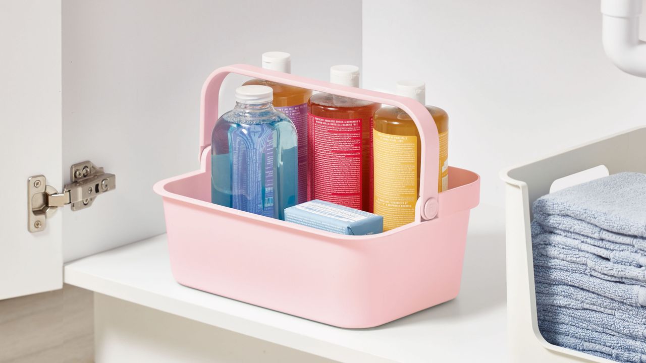 Pink under sink storage caddy filled with products