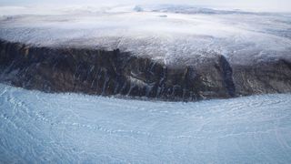 A section of glacier (bottom of image) is seen from NASA's Operation IceBridge research aircraft along the Upper Baffin Bay coast on March 27, 2017, above Greenland.
