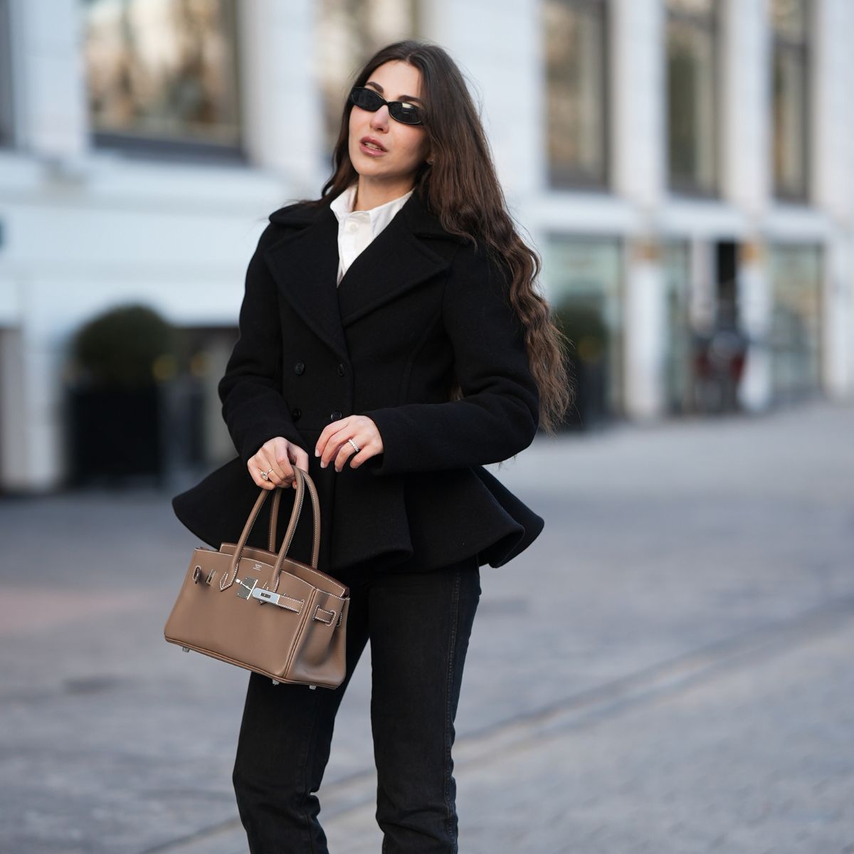street style shot of woman wearing peplum jacket