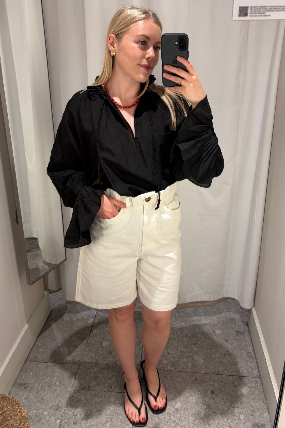 Woman wears white blouse, brown linen trousers
