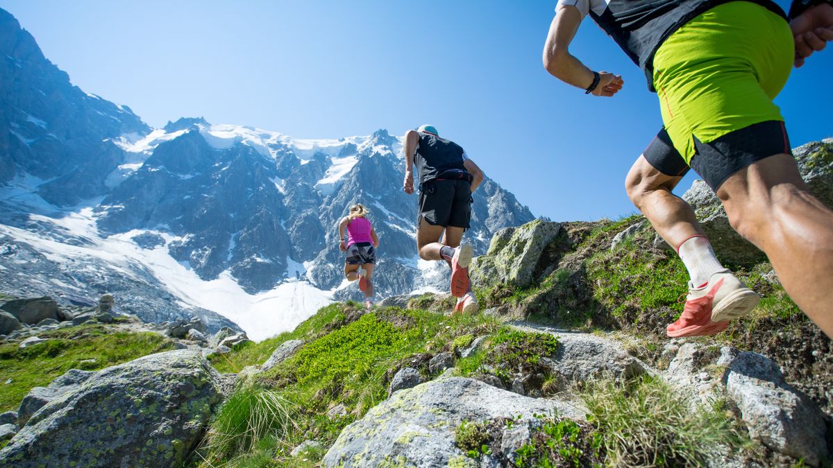 Three trail runners in the mountains