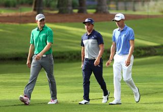 Jordan Spieth, Rickie Fowler and Justin Thomas walk down a fairway chatting