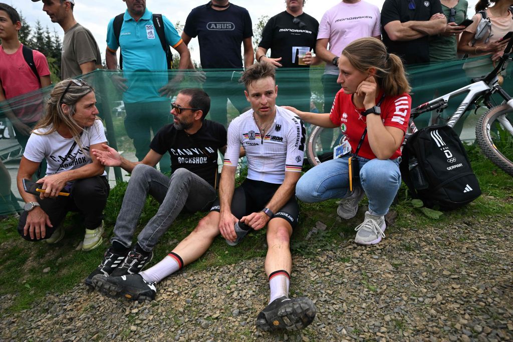Germanys Luca Schwarzbauer receives medical treatment after a fall during the mens elite mountain bike crosscountry short track race at the Cycling World Championships in Glentress Forest Scotland on August 10 2023 Photo by Oli SCARFF AFP Photo by OLI SCARFFAFP via Getty Images