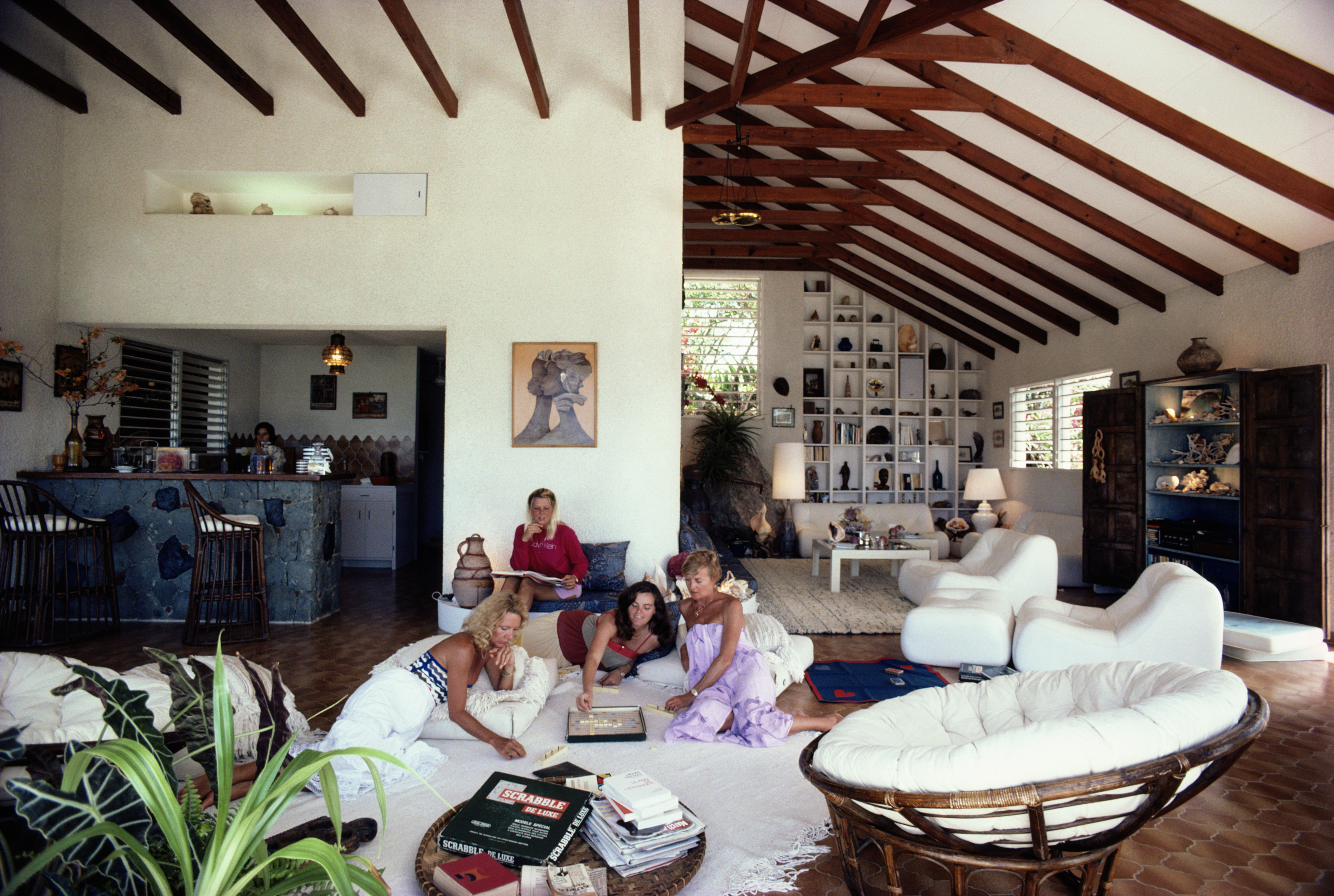 A group of women playing a board game in a house on Saint Barthelemy in the Caribbean, March 1983. (Photo by Slim Aarons/Hulton Archive/Getty Images)