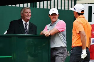 Rory McIlroy and Rickie Fowler talk with starter Ivor Robson (L) on the first hole during the final round of The 143rd Open Championship at Royal Liverpool on July 20, 2014