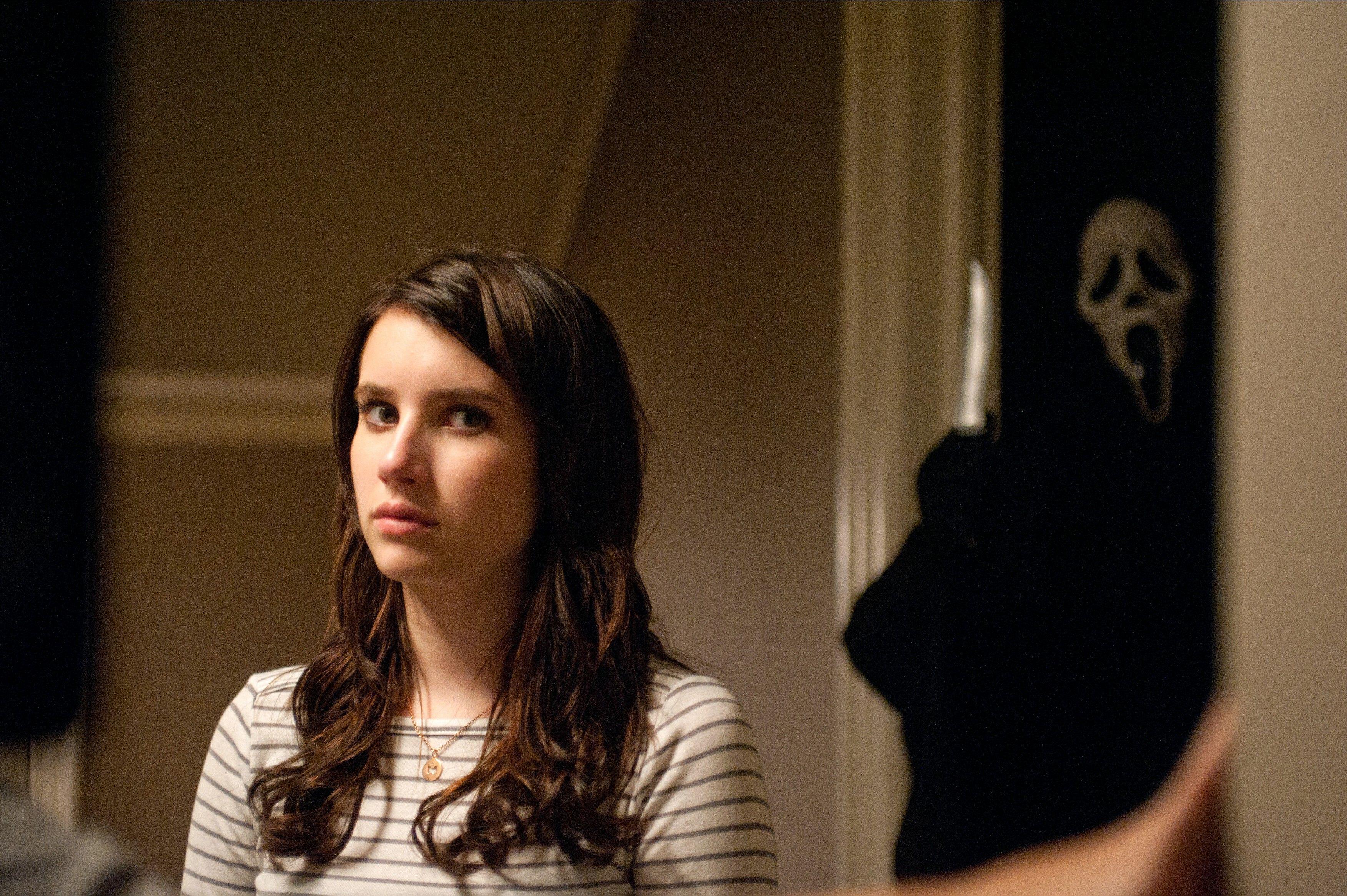 Emma Roberts as Jill Roberts, with Ghostface behind her in Scream 4