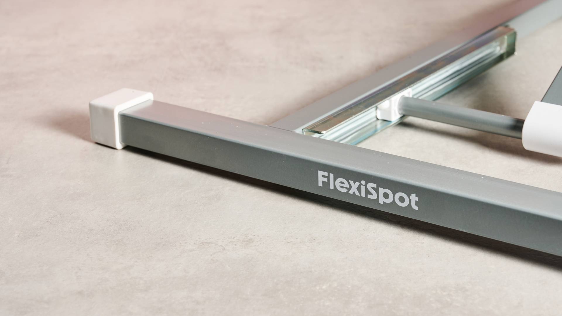 Close-up of the Flexispot logo on the support leg.