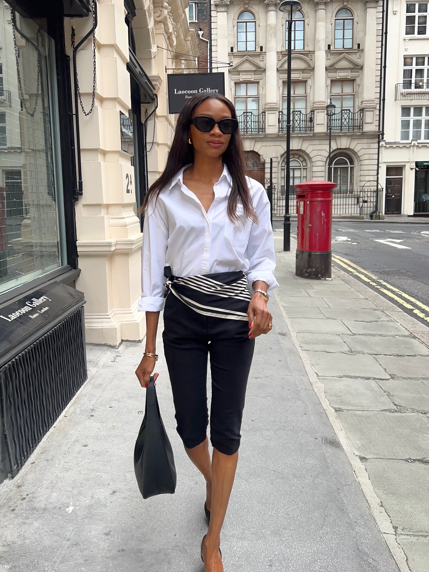 An image of @symphonyofsilk wearing a white button-down with capri pants and a scarf belt, an example of what to wear instead of skinny jeans.