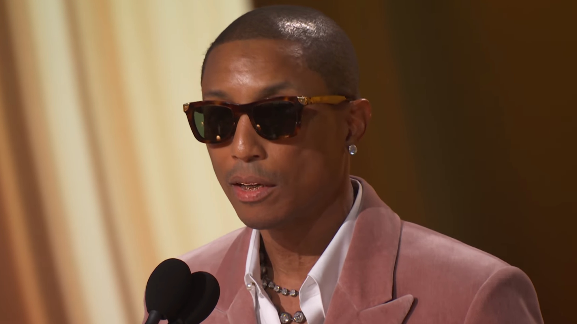 Pharrell Williams accepts an award at the 2026 Grammys.