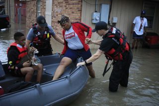 First responders rescue a resident from floodwater left behind by Hurricane Ida in LaPlace, Louisiana, U.S., on Monday, Aug. 30, 2021.