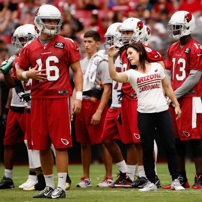 NFL Female Coach on field with players