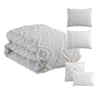 A grey and cream diamond pattern tufted bedding set with shams and accent pillows
