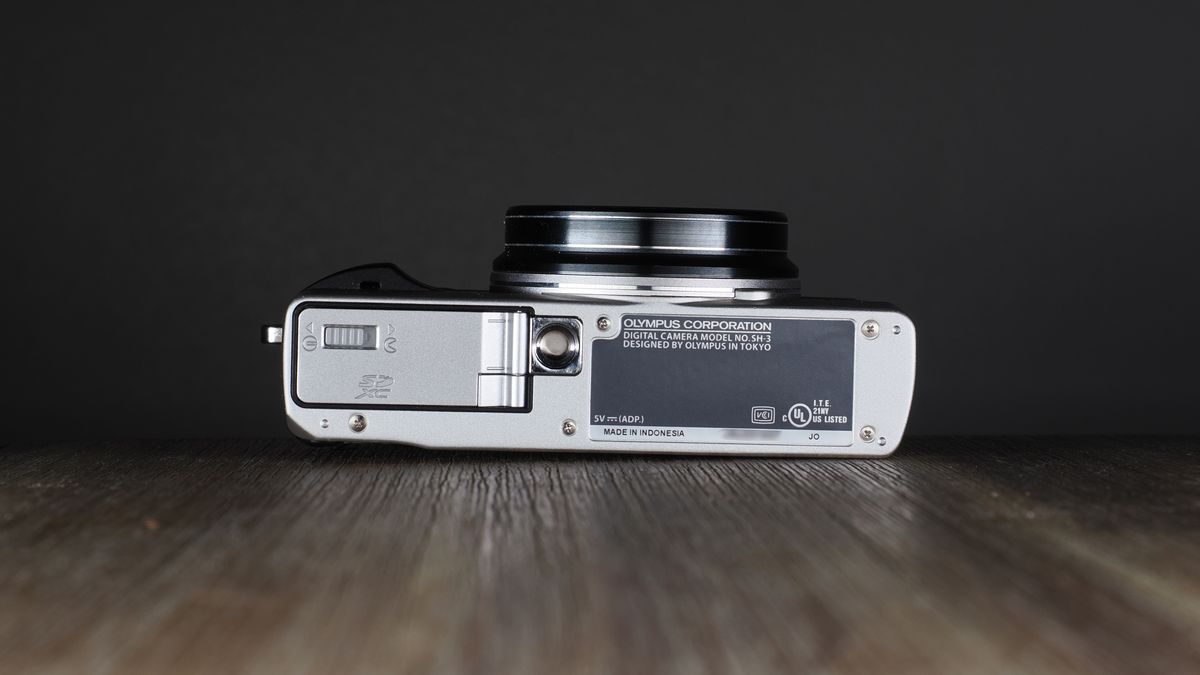 Olympus Stylus SH-3 on a wooden surface