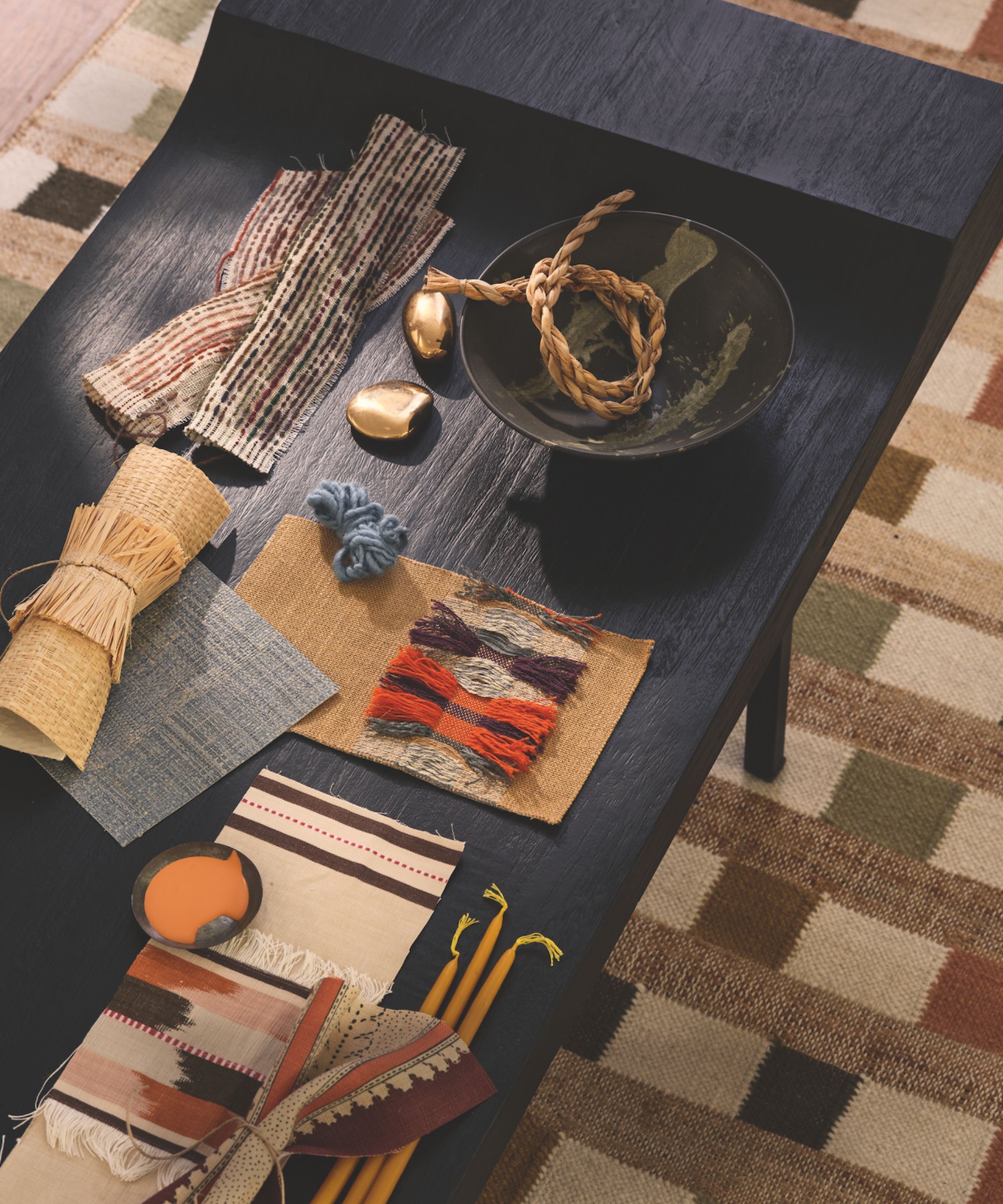 Black coffee table with multiple fabric swatches