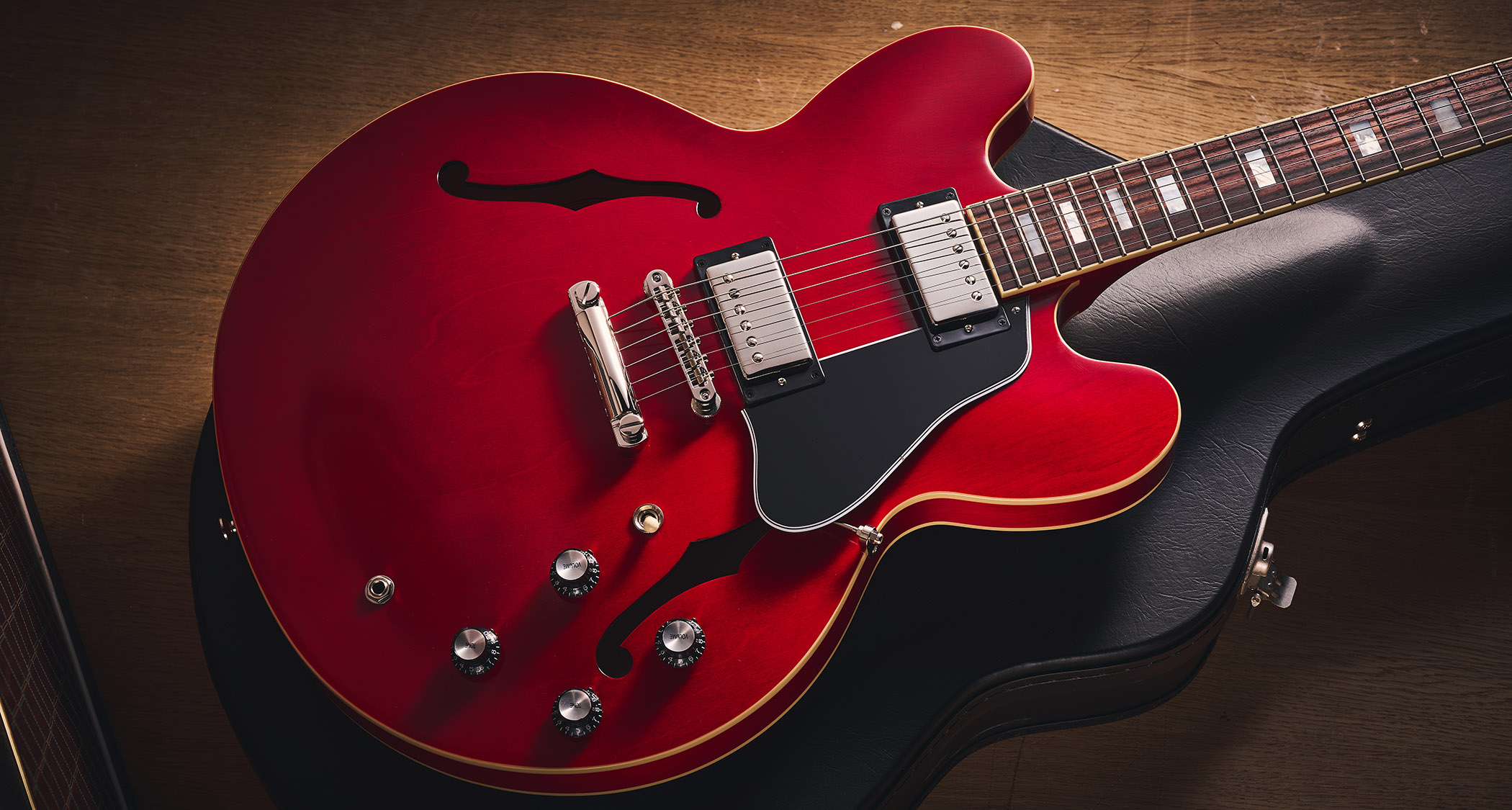 Epiphone Inspired By Gibson Custom 1962 ES-335 Reissue: the handsome semi-hollow electric is finished in Sixties Cherry and is photographed against various backgrounds.
