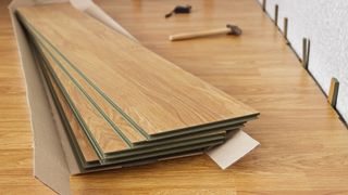 Laminate flooring planks on top of floor