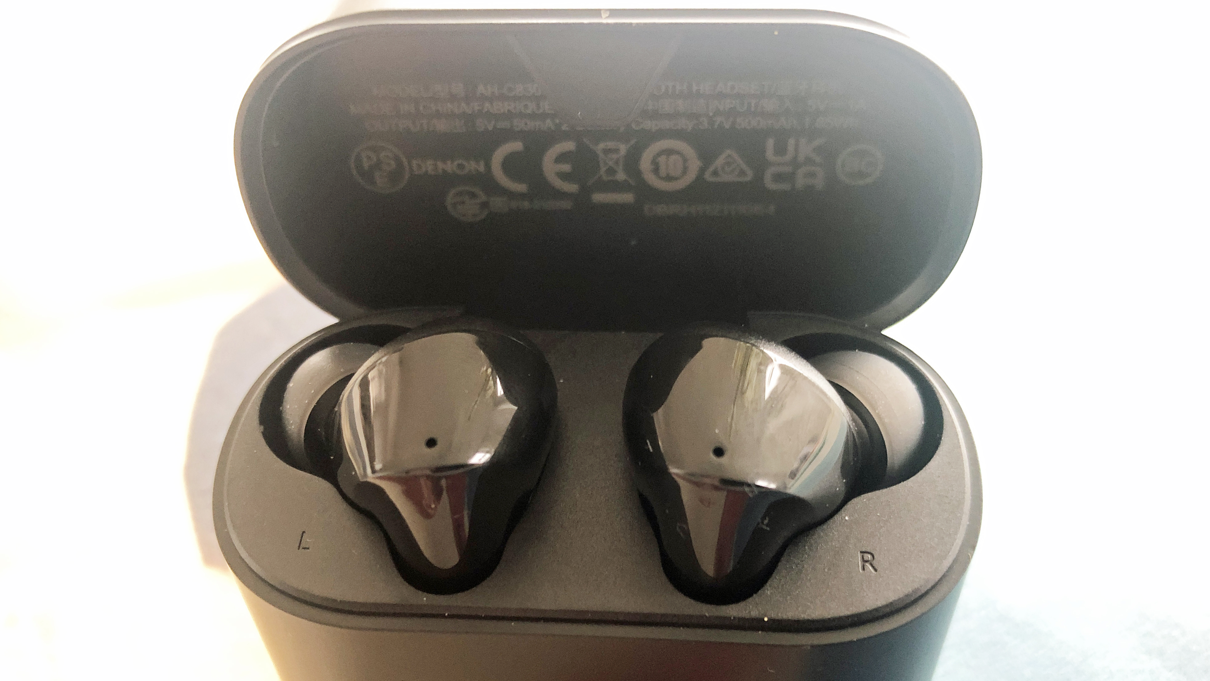 the denon true wireless earbuds in their charging case