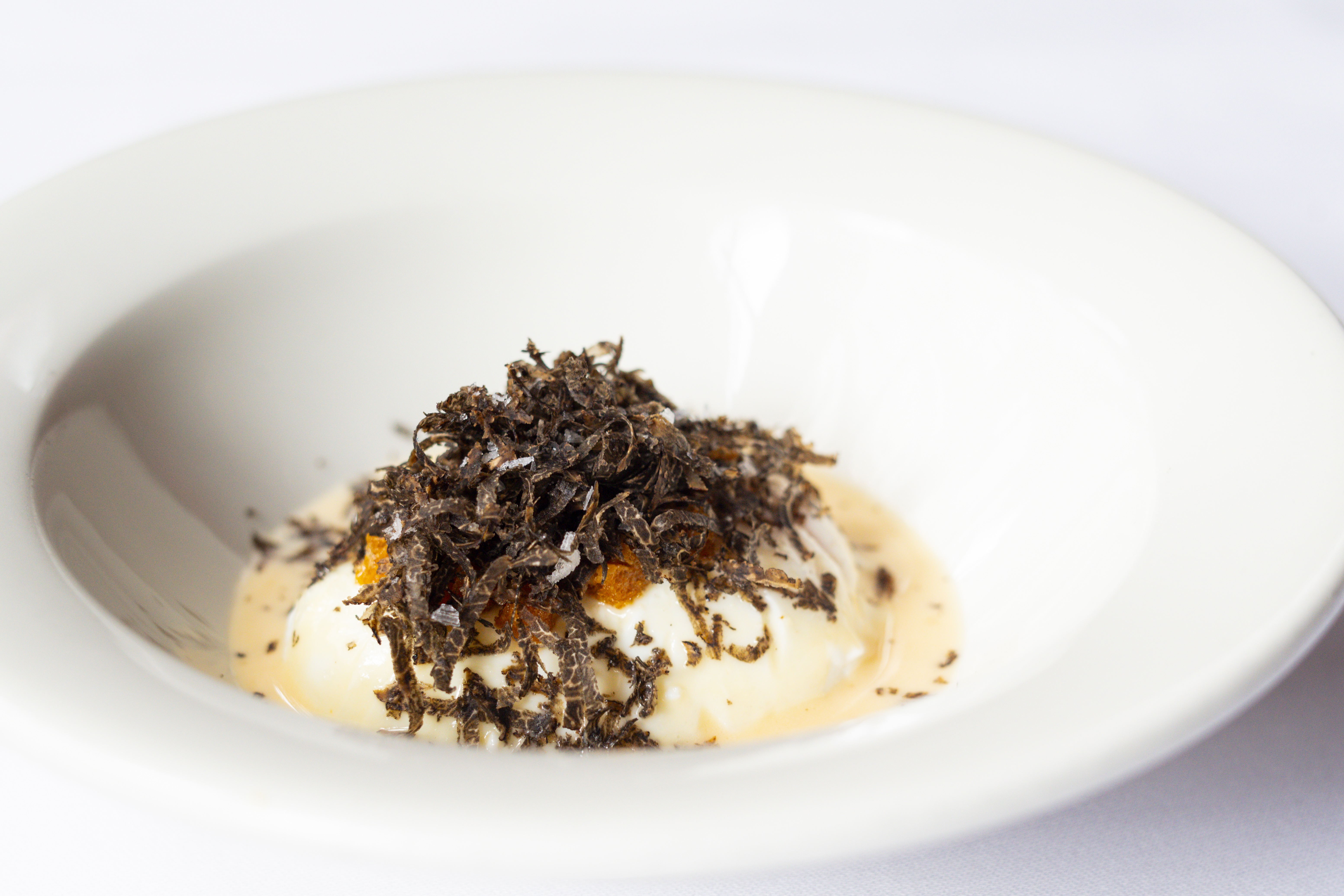 Poached egg covered in shaved truffle