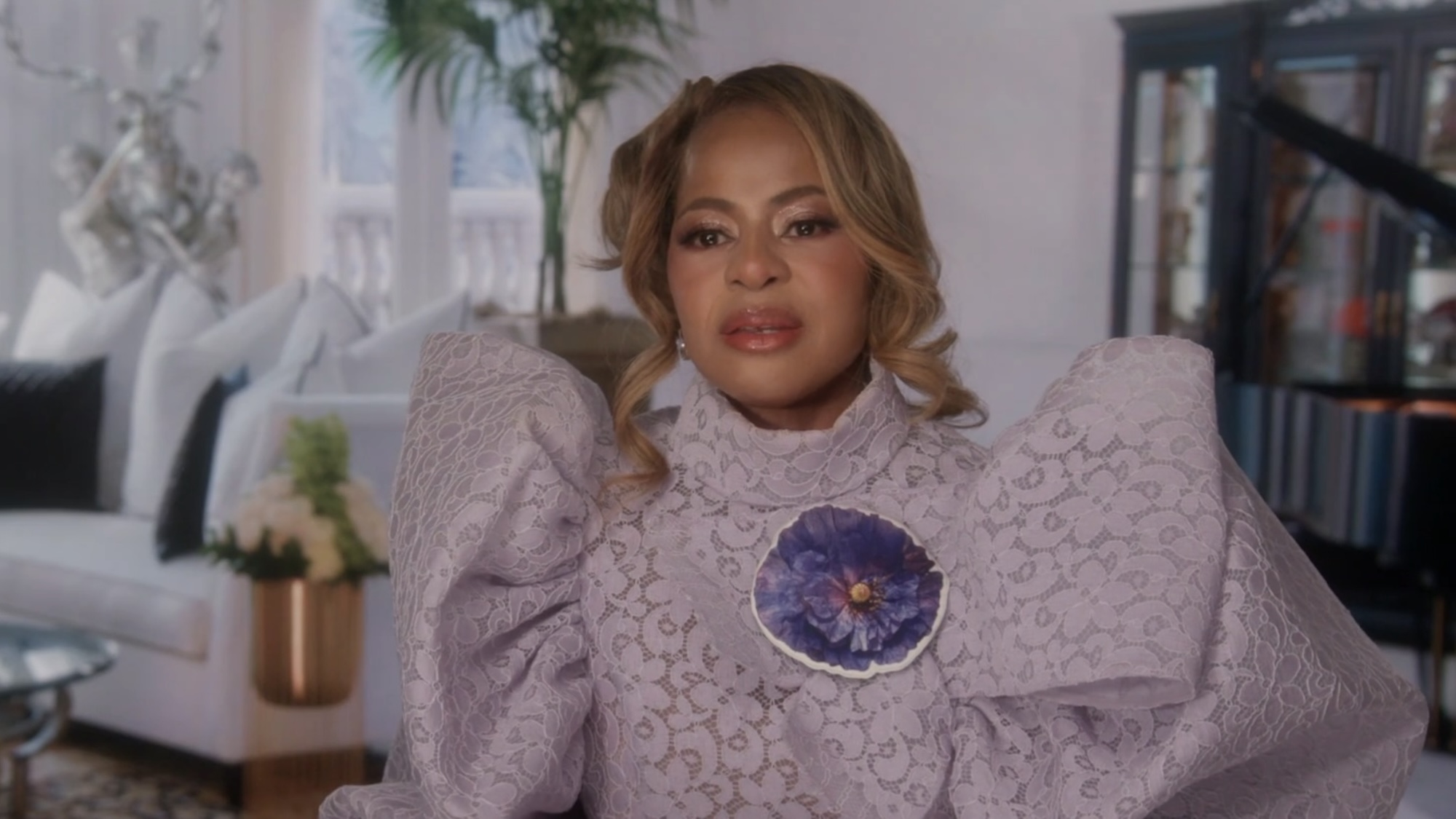 Mary Cosby wearing a bold purple outfit and updo in a confessional for RHOSLC