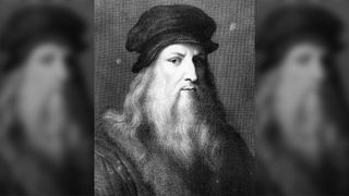Black and white portrait of Leonardo da Vinci. He has long white hair and a long white beard. He is wearing a black hat.