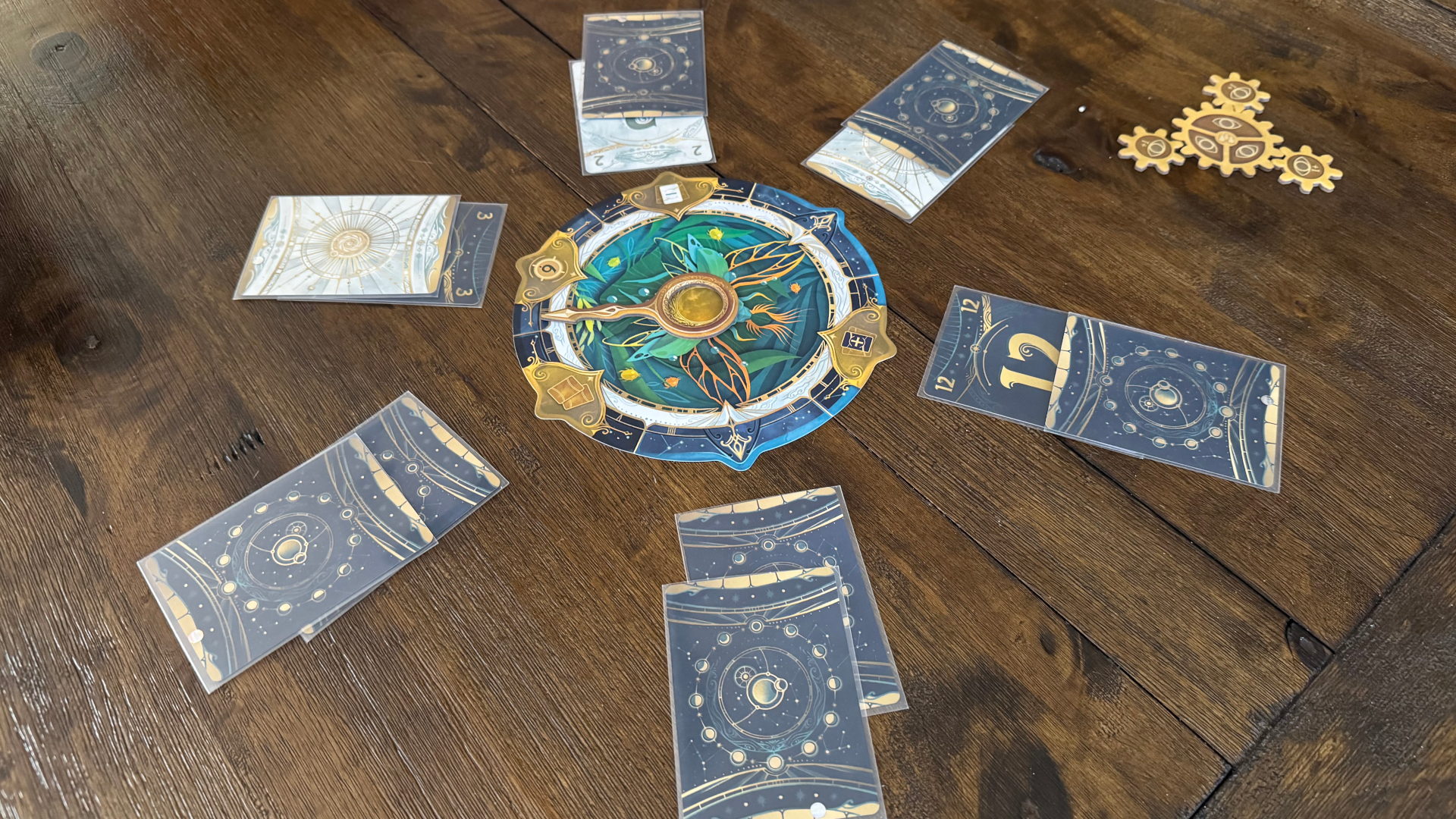 Cards arranged on a wooden table around the outside of a clock