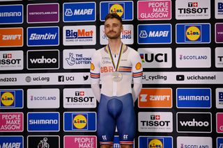 Silver medalist Daniel Bigham of United Kingdom celebrates winning during the medal ceremony after the men's elite individual pursuit finals at the 96th UCI Glasgow 2023 Cycling World Championships