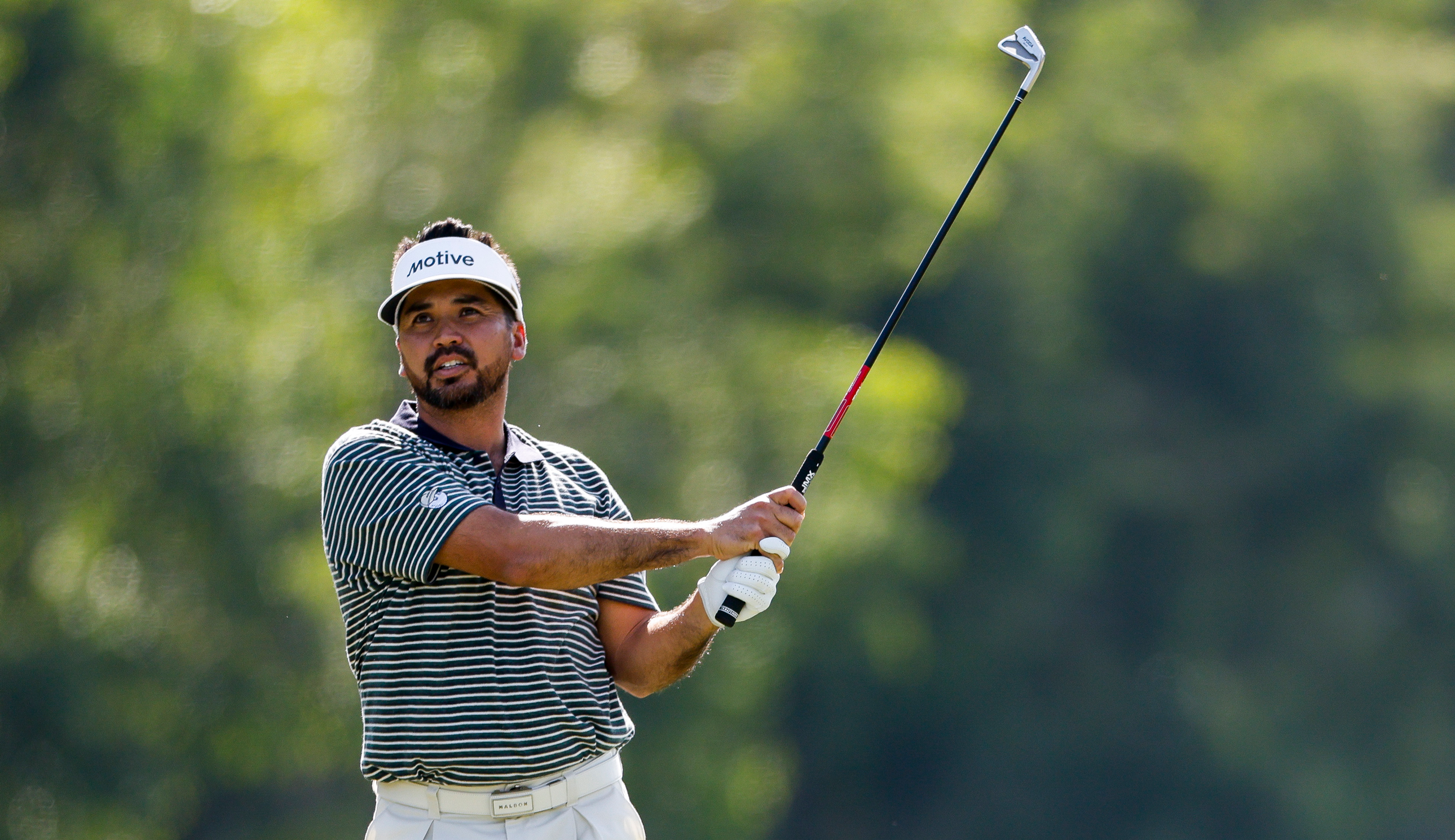 Jason Day hits an iron and watches its flight