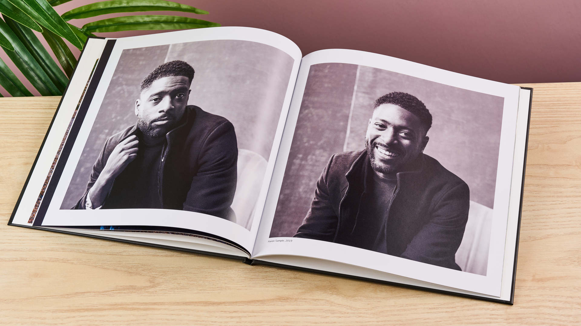 The Once Upon photo book sits open on a spread of two black and white portraits.