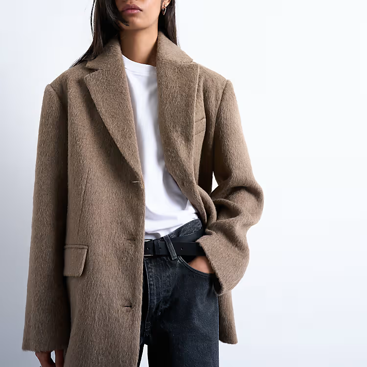 A model wearing a brown wool blazer.