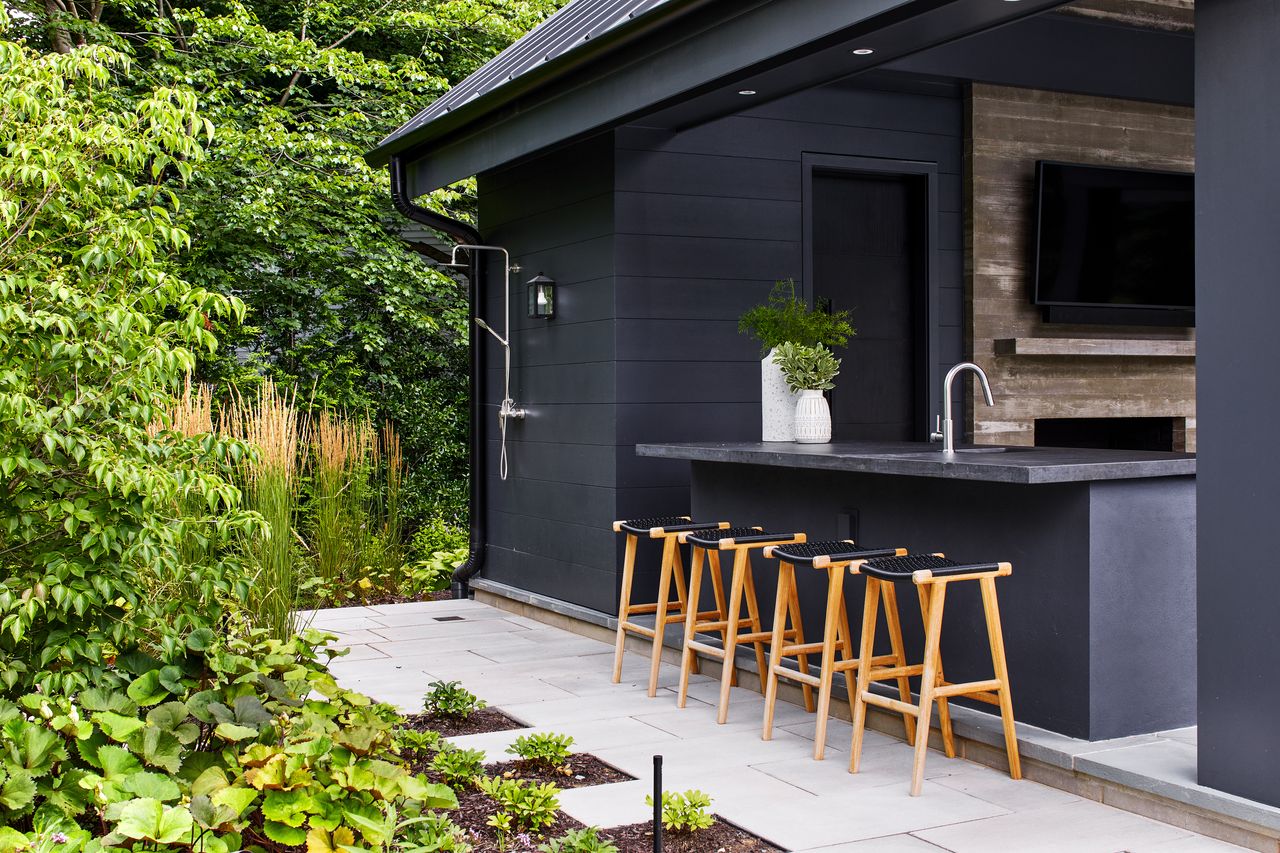 An outdoor kitchen plus shower and garden