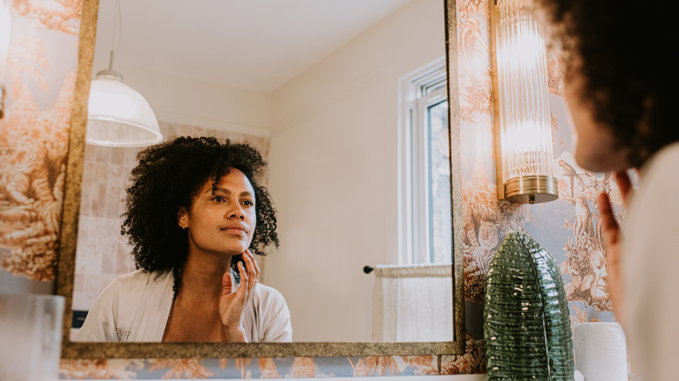 Woman at herself in the mirror