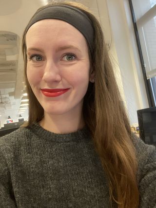 Halie LeSavage wears red cline lipstick at the office with a gray sweater and headband