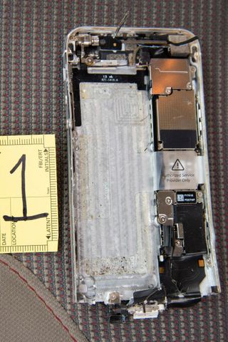 A heavily damaged iPhone 5 allegedly used by the gunman in the Naval Air Station Pensacola shootings.