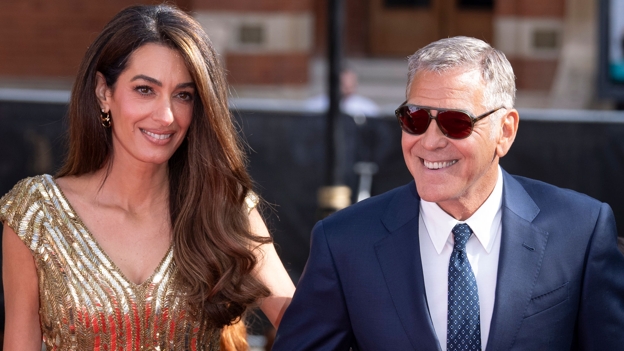 Amal Clooney wears a gold floor-length sequin gown at the King's Trust event red carpet