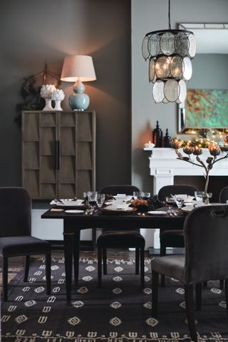 grey dining room with layered lighting