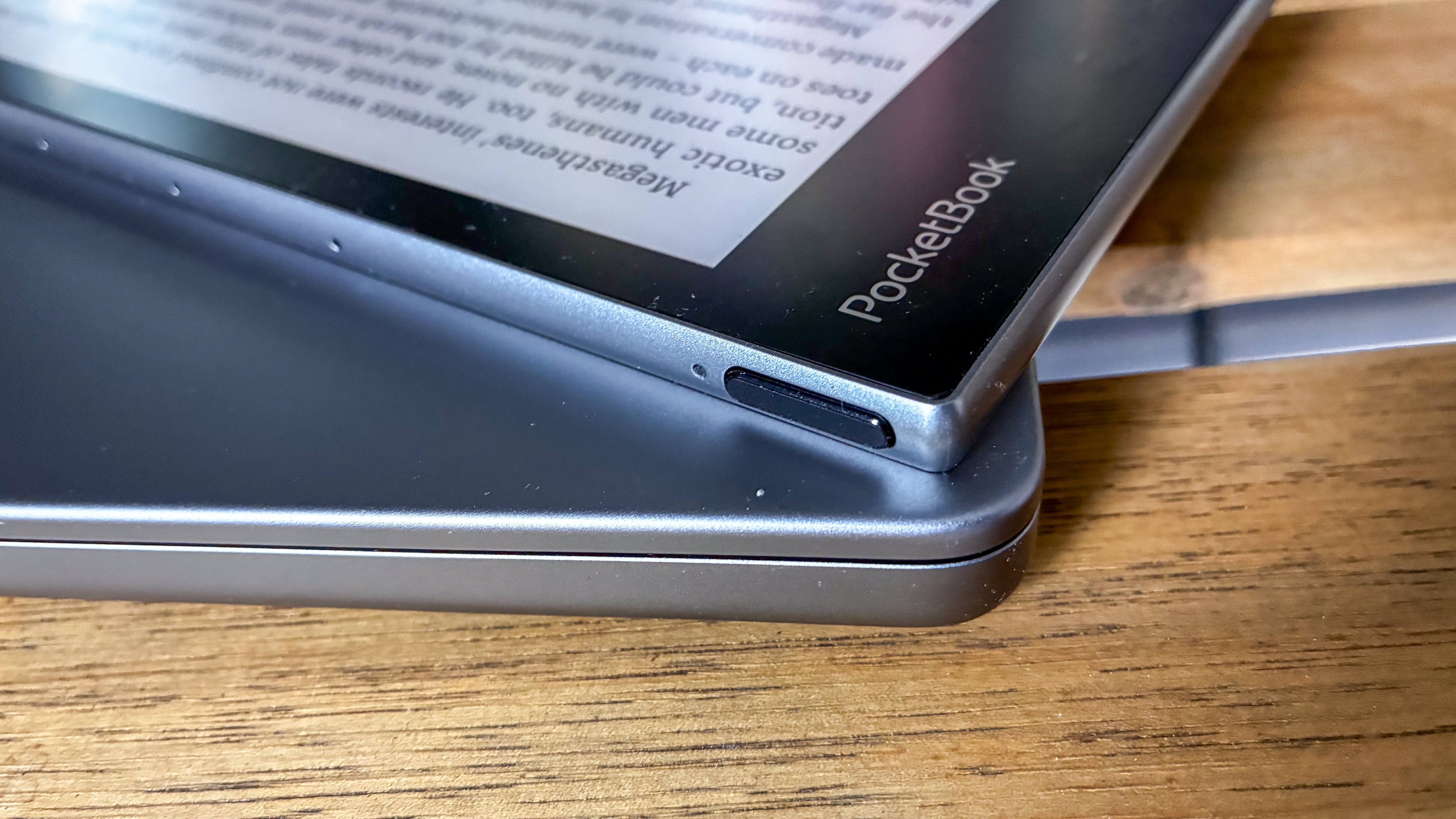 The power button on the top left corner of the PocketBook InkPad Eo