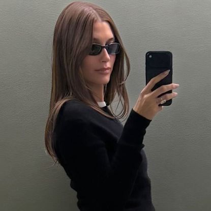 Hailey Bieber paired a leather midi skirt with matching knee-high leather boots, vintage Gucci by Tom Ford